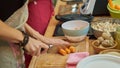 Female ChefÃ¢â¬â¢s Hands Cut Carrots in A Vegan Setting